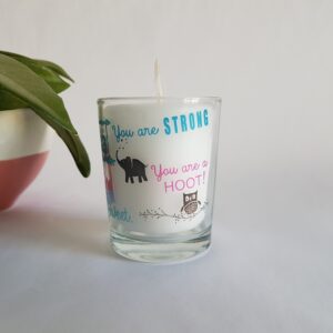 White votive candle in a customised glass container